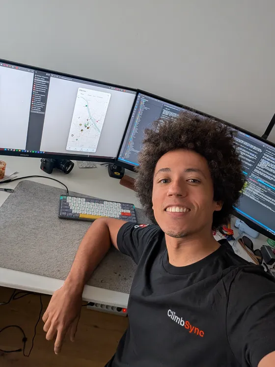 Benjamin at his desk in a ClimbSync shirt, the app open on screen